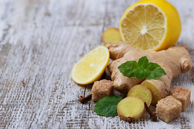 Ginger, lemon and mint on light background