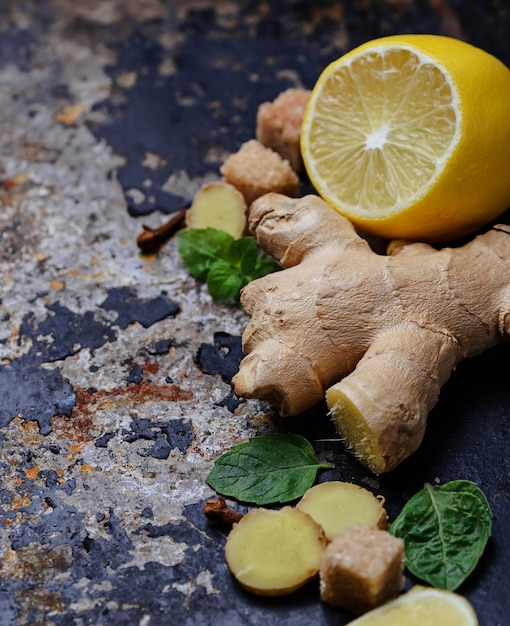 Ginger, lemon and mint on old dark background