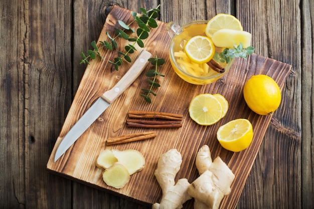 Ginger and lemon tea on wooden table