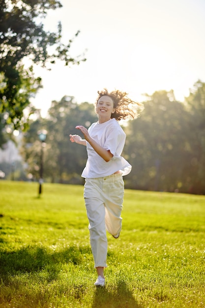 A ginger long-haired girl spending time in a park feeling happy