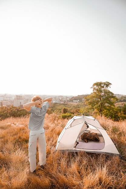 A ginger man in the countryside and feeling relaxed