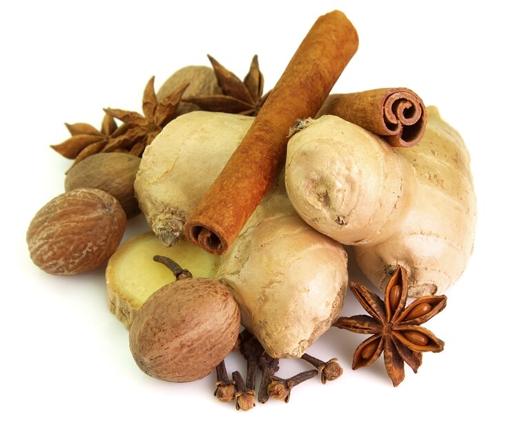 Ginger, nutmeg, cinnamon, anise and carnations on a white background