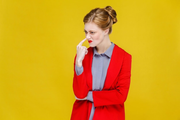 Ginger red head business woman in red suit showing liar bizarre sign