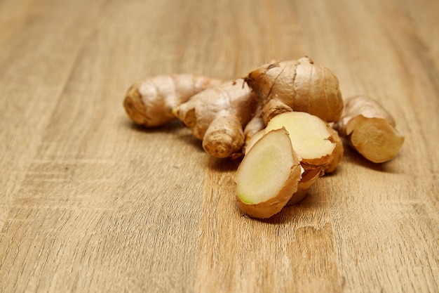 Ginger root sliced on wooden table