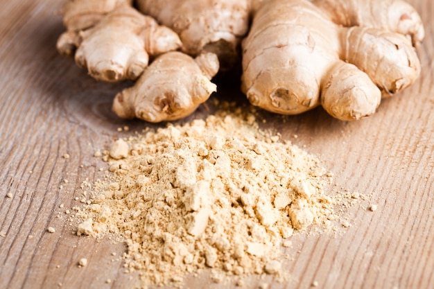 Photo ginger root and spice closeup on wooden table