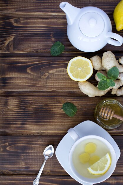 Ginger tea and ingredients on the brown wooden  background.Top view.Copy space.