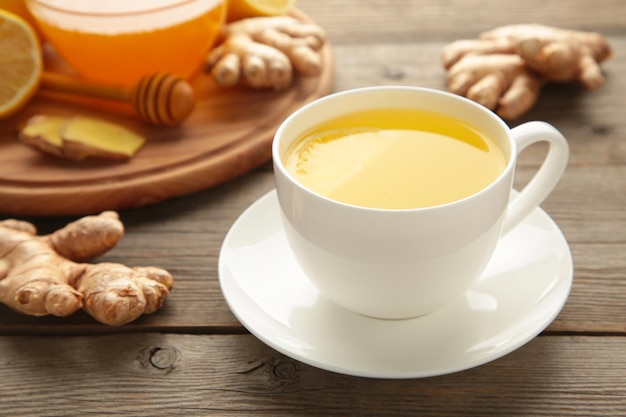 Ginger tea with lemon and honey on grey wooden background. Top view