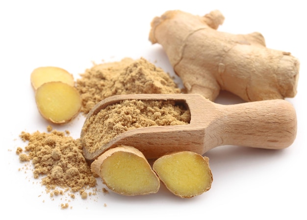 Ginger with dried powder over white background