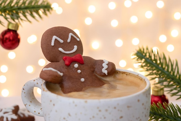 Gingerbread cookie man in a hot cup of cappuccino