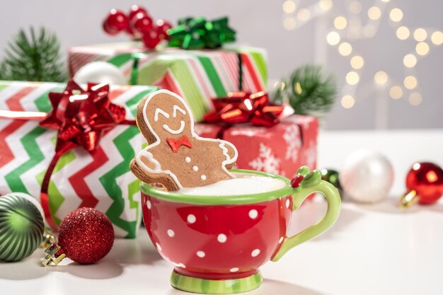 Gingerbread cookie man in a hot cup of cappuccino