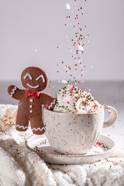 Gingerbread cookie man with a hot chocolate