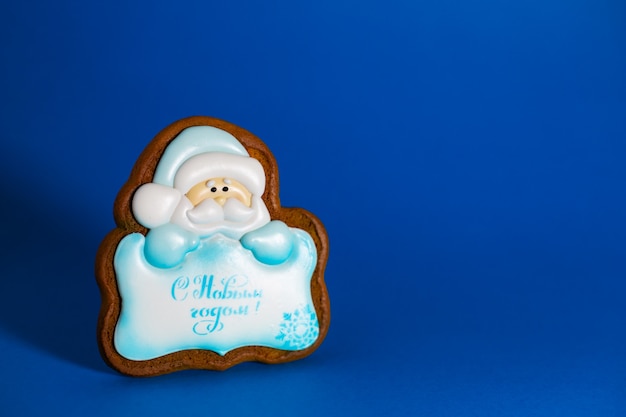 Gingerbread cookie of Santa's with copyspace on blue background