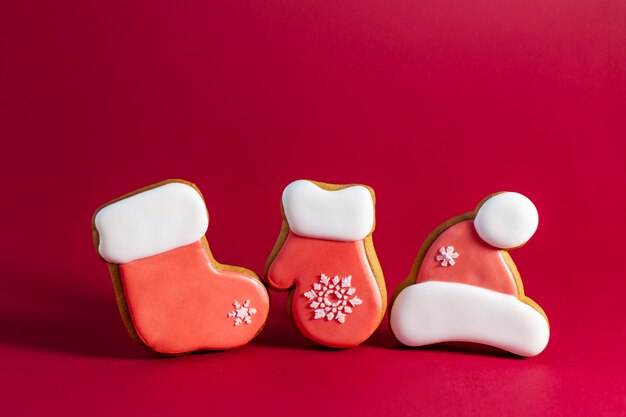 Gingerbread cookie of Santas clothes on red 