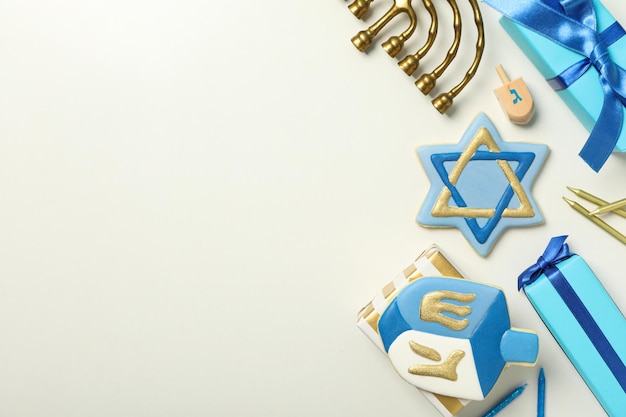 Gingerbread cookies gift boxes and Hanukkiah on white background space for text