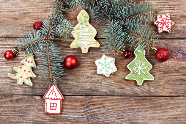 Gingerbread cookies with Christmas decoration on wooden table background