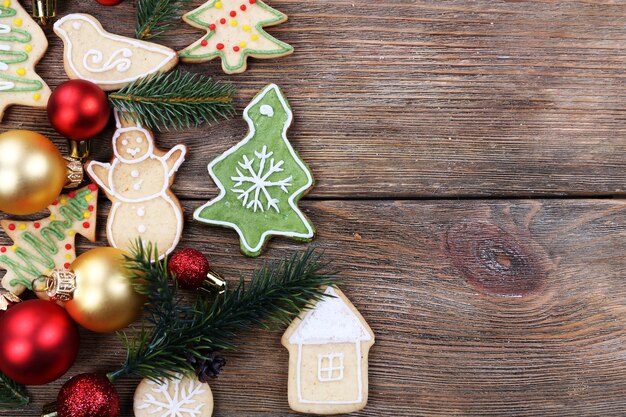 Gingerbread cookies with Christmas decoration on wooden table surface