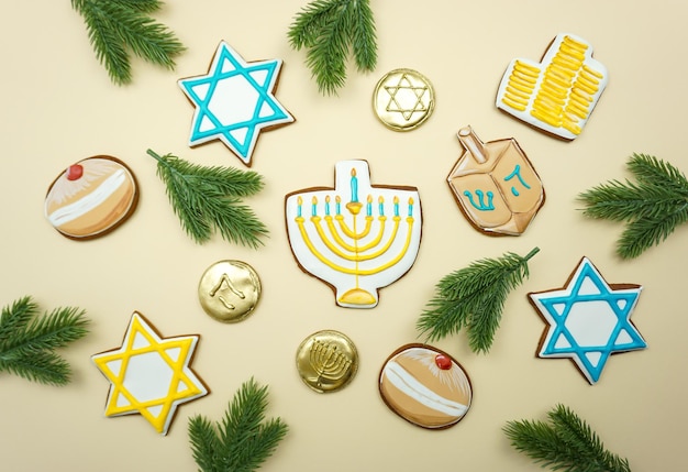 Gingerbread cookies with symbols of the Hanukkah holiday are laid out on the background