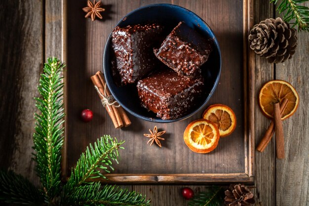 Gingerbread cubes with chocolate glaze and fruits for Christmas