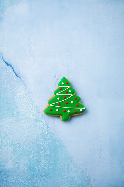 Gingerbread in the form of Christmas trees on blue.   