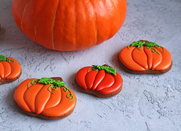 Gingerbread handpainted in the form of pumpkins on a light background