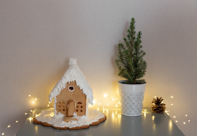 Gingerbread house small Christmas tree on coffee tableChristmas holiday food concept