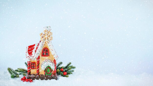 Gingerbread house on snow with fir branches Christmas background stock image