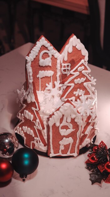 a gingerbread house with a red roof and a white door