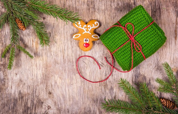 Gingerbread and knitted gift on wooden table