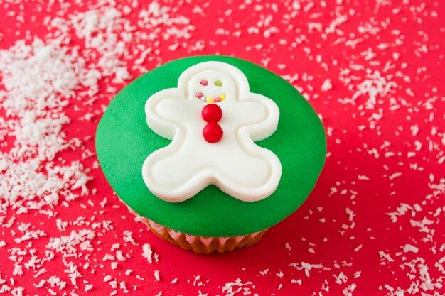 Gingerbread man cupcake on red background