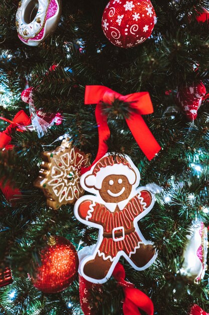 Gingerbread man hanging on the Christmas tree Holiday Party Decoration or postcard concept