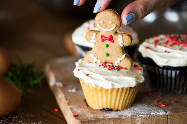 Gingerbread man on top of a cupcake