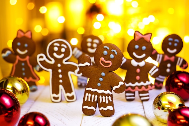 Gingerbread man and woman dance  on a bright golden background