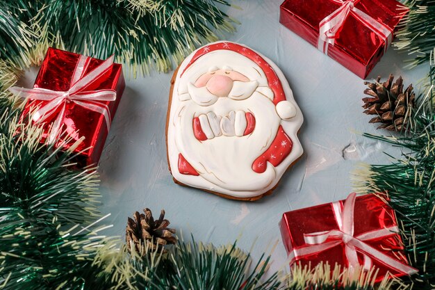 Gingerbread Santa Claus on a festive blue background, Happy New Year, horizontal orientation