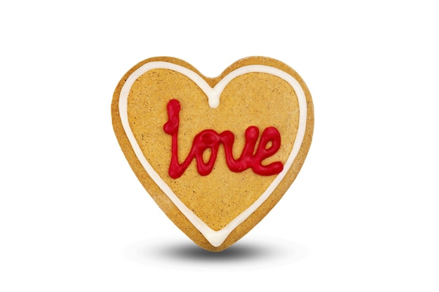 Gingerbread in the shape of heart with the inscription love isolated on white background