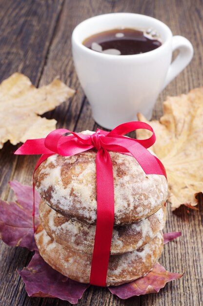 Gingerbread tied with red ribbon and cup of coffee