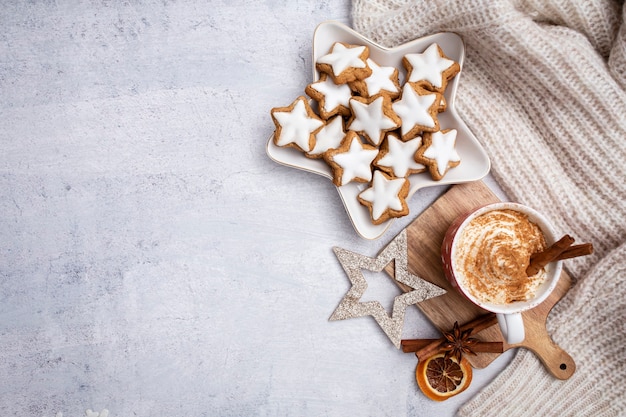 Gingerbread with mug of hot chocolate and christmas candy cane.