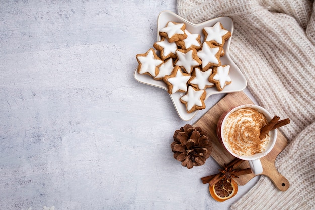 Gingerbread with mug of hot chocolate and christmas candy cane.