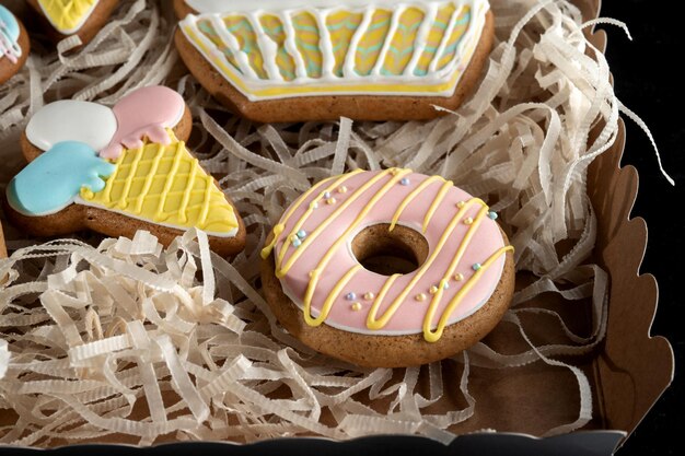 Gingerbreads in the form of a donuts ice cream and cakes Laid out in a gift box Macro