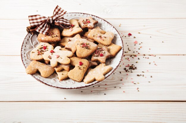 Gingerbreads platebowChristmasholiday and new year conceptWhite wooden table