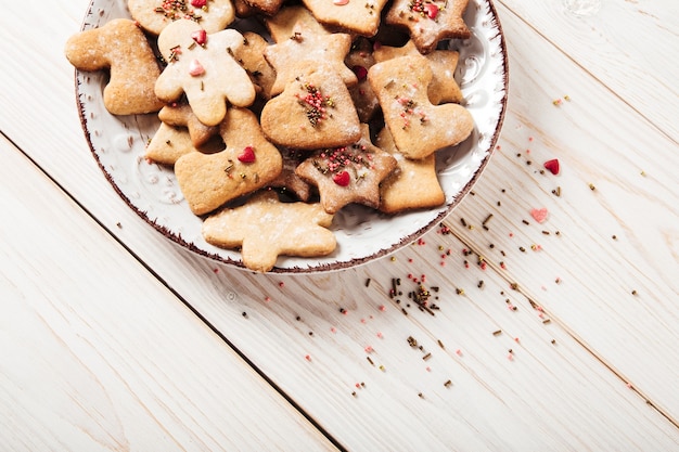 Gingerbreads plateChristmasholiday and new year conceptWhite wooden table