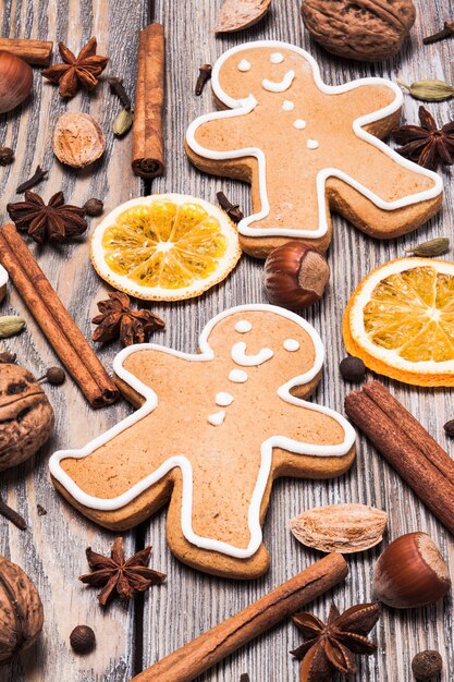 Gingerbreads with spices on the wooden table. Christmas aroma decor