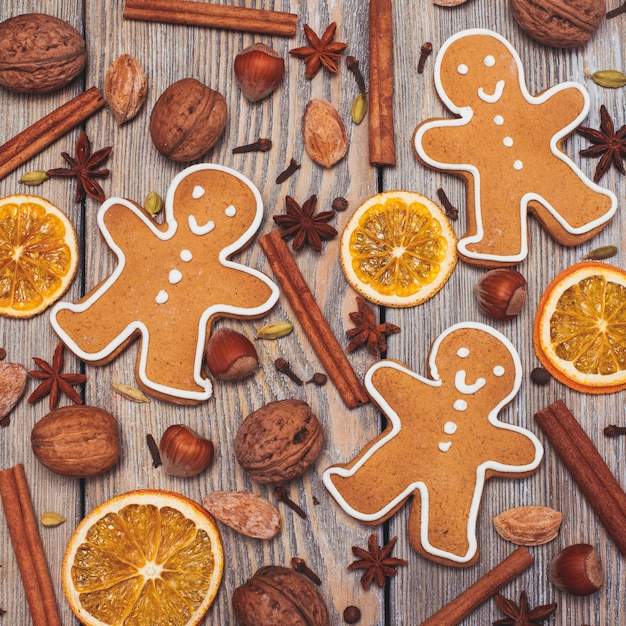 Gingerbreads with spices on the wooden table. Christmas aroma decor