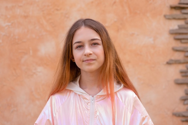 Girl 11 years old on a background of beige wall Teen girl portrait