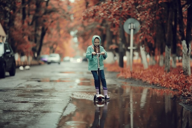 Girl 6-7 runs in the autumn park