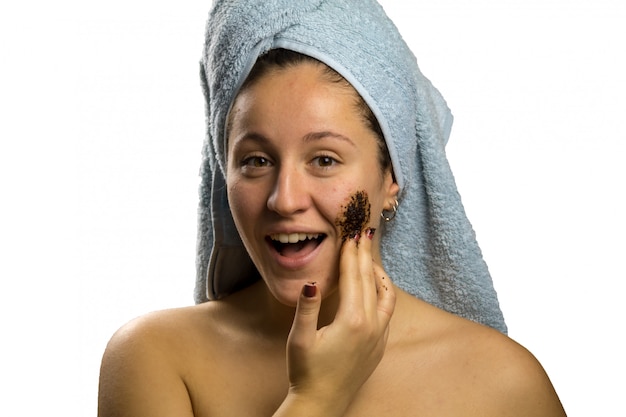 Girl after shower with a towel and different facial expressions, face with homemade coffee cream