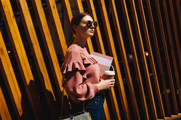 Girl against a wooden wall