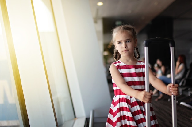 Girl in airport during her summer travel