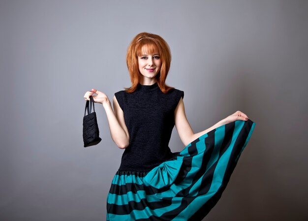 Photo girl in american 50s-60s style with handbag.