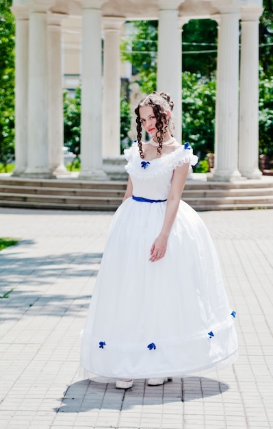 Girl in ancient dress with crinoline on the background of the rotunda