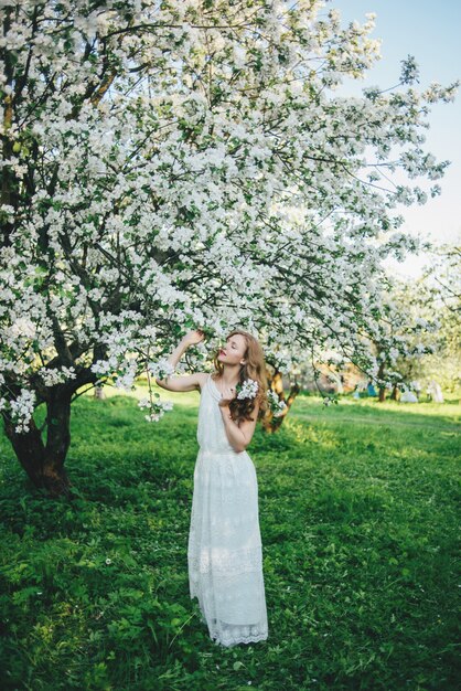 A girl in an apple orchard